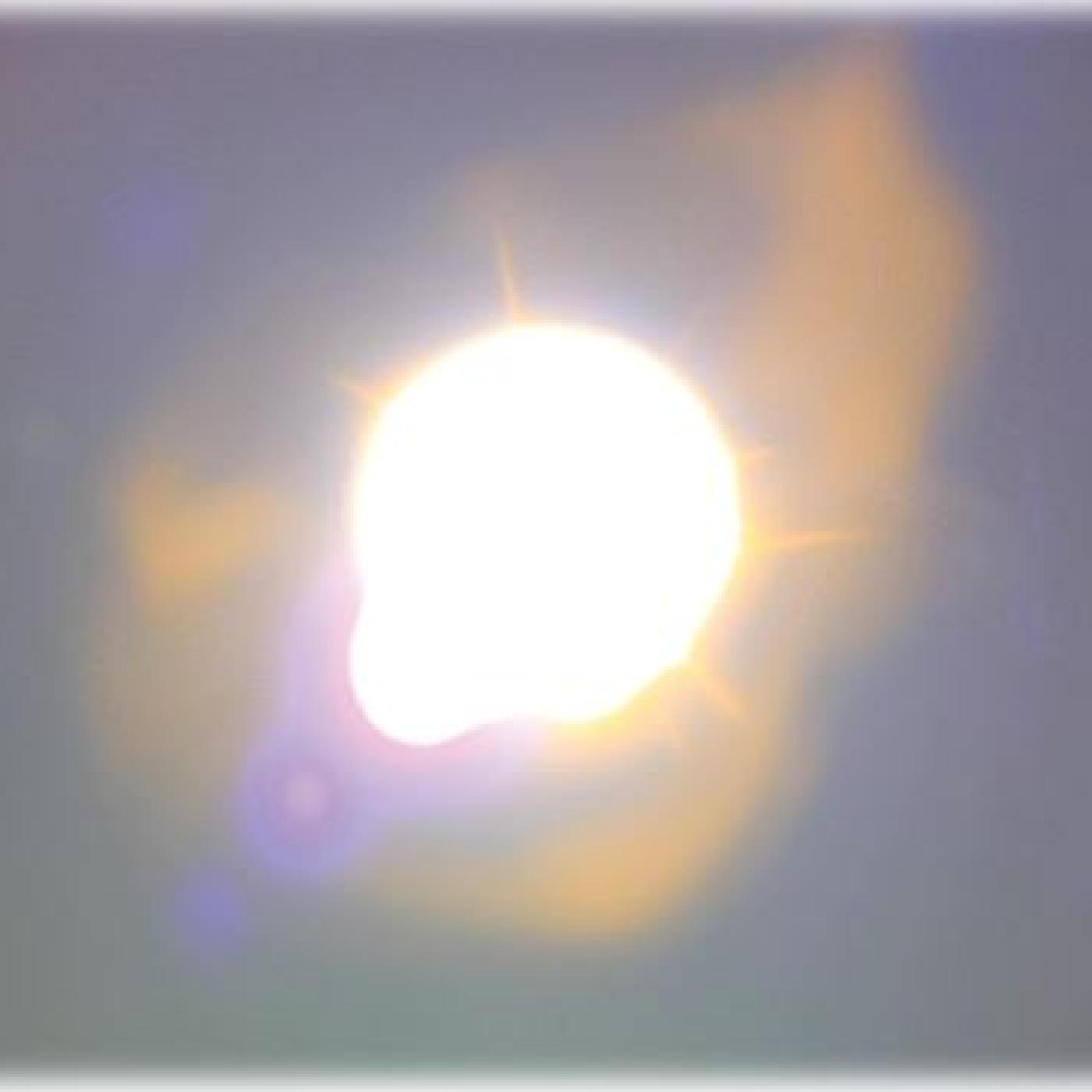 Two cylinders on each side of the photo are pointing to bright glowing orb in the center. 