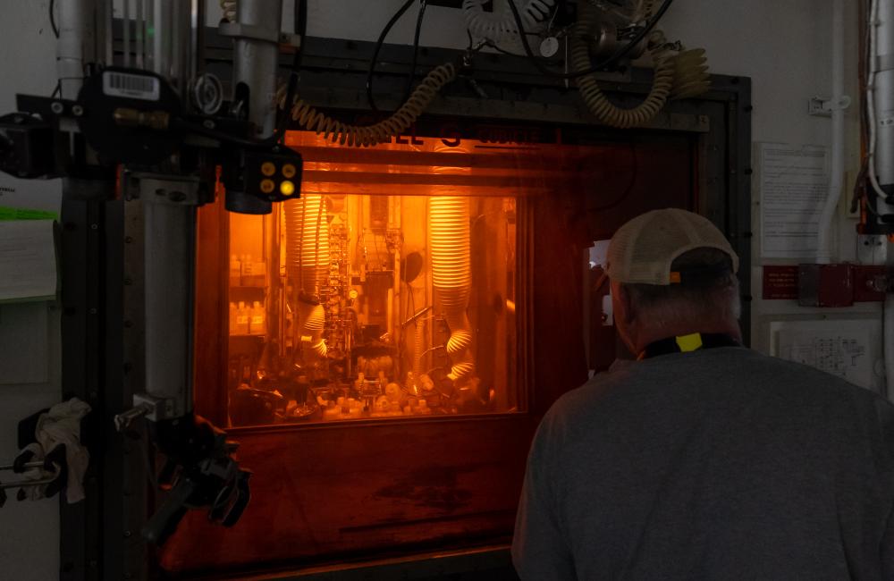 SCoR Safety Poster - MVRP - Leaders value the safety legacy they create in their discipline - Sam Schrell and 3 team members working with manipulators in hot cell face for Cf-252, May 28, 2021.